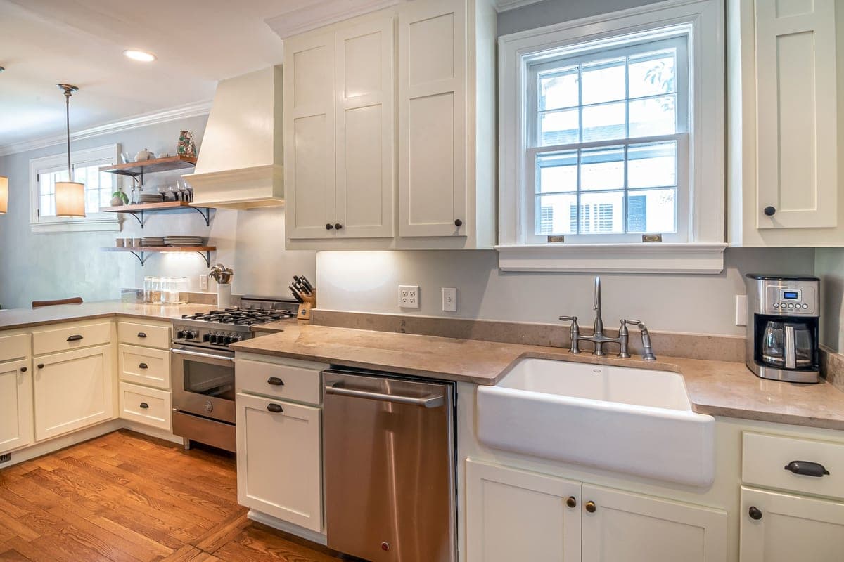 Farmhouse apron sink with a tall faucet above it