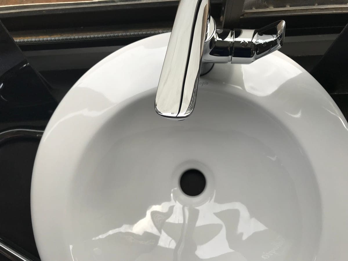 Close detail of a stainless steel sink basin wall and corner radius