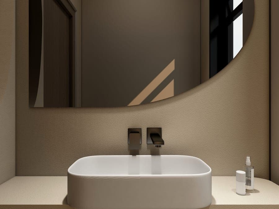 High-arc pull-down kitchen faucet in brushed nickel beside a window